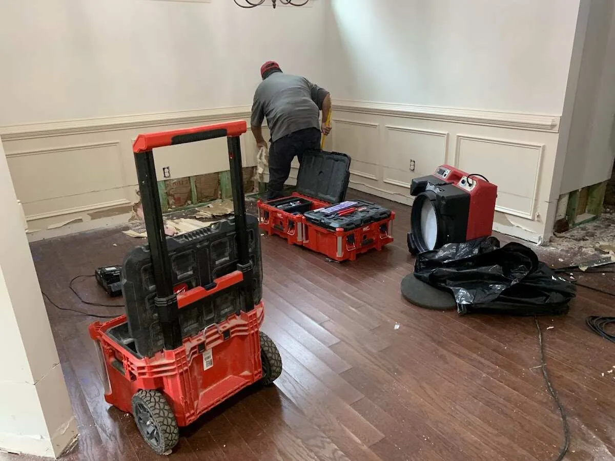 Technician setting up drying equipment for water damage in Dalhart